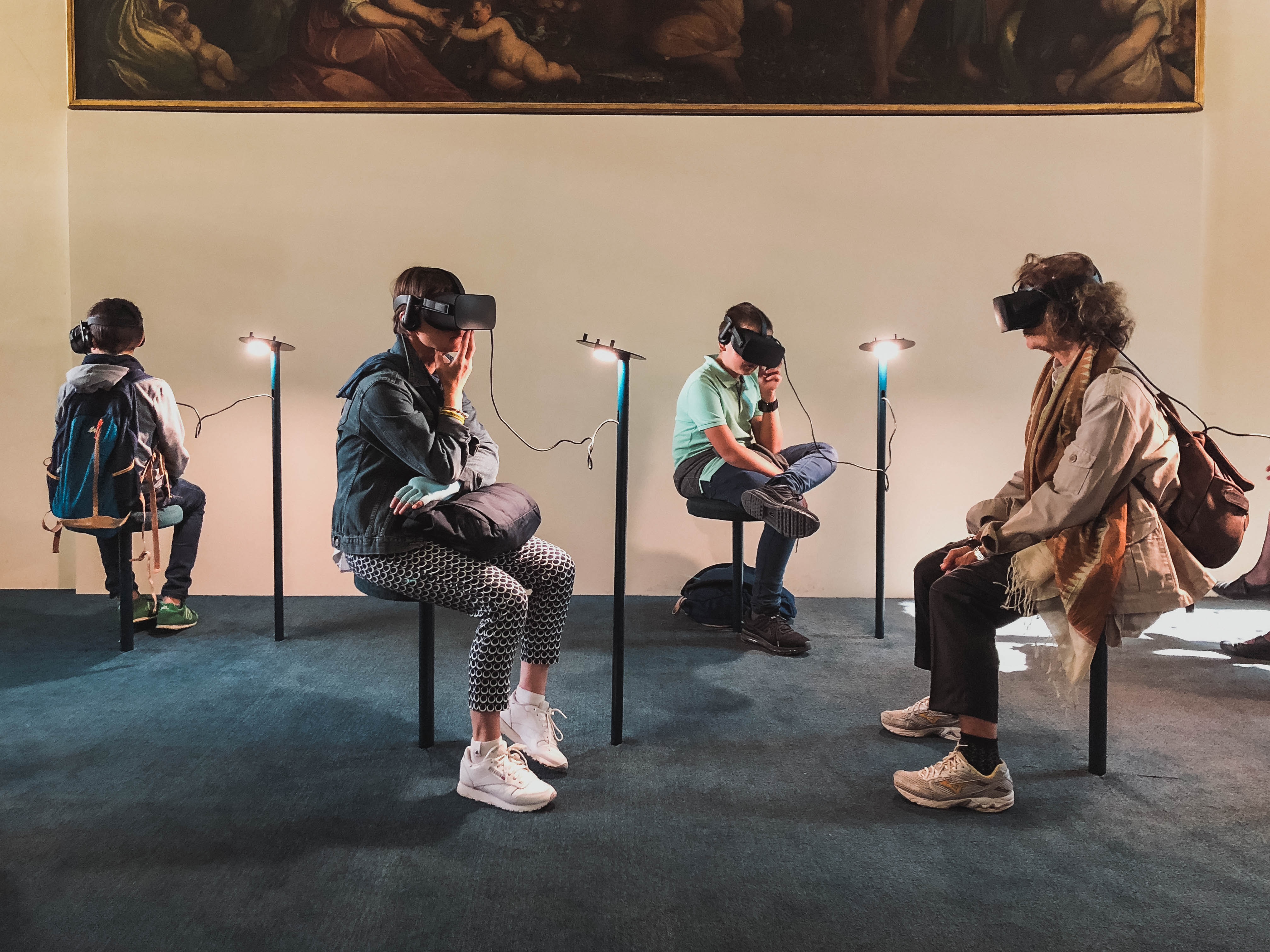 Four people sitting in a room experiencing 360 video content on a VR headset