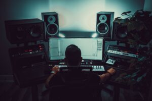 A music producer in a studio composing background music 