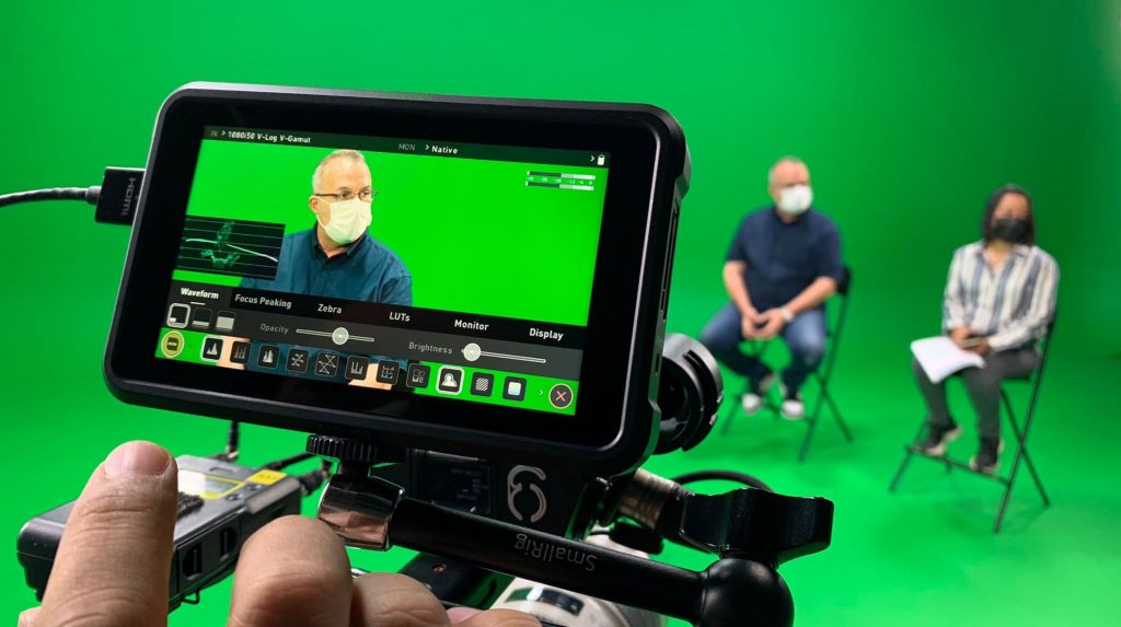 filming two subjects in green screen studio