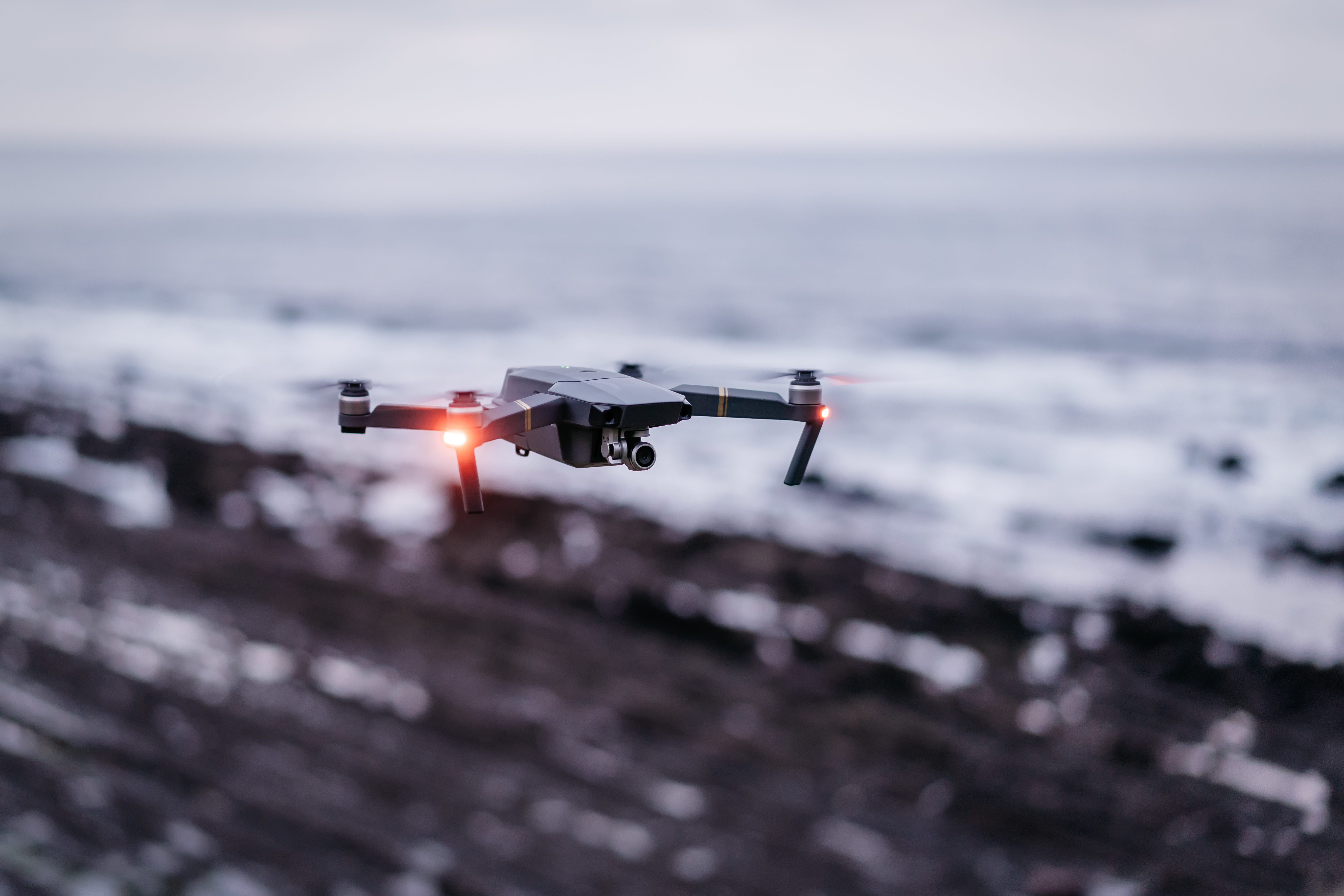 Camera drone flying outdoors over the sea
